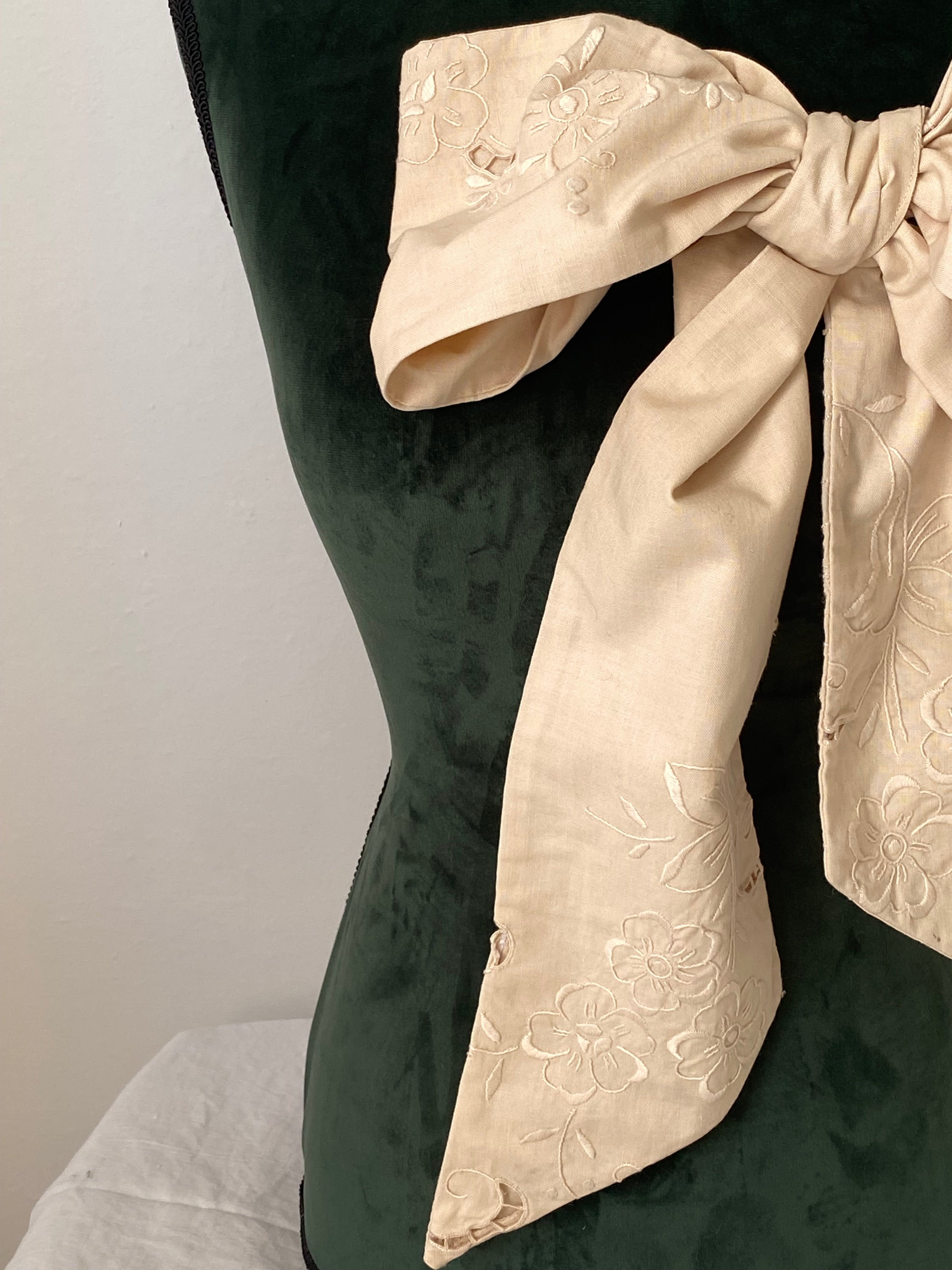 Tailored bow with antique embroidery