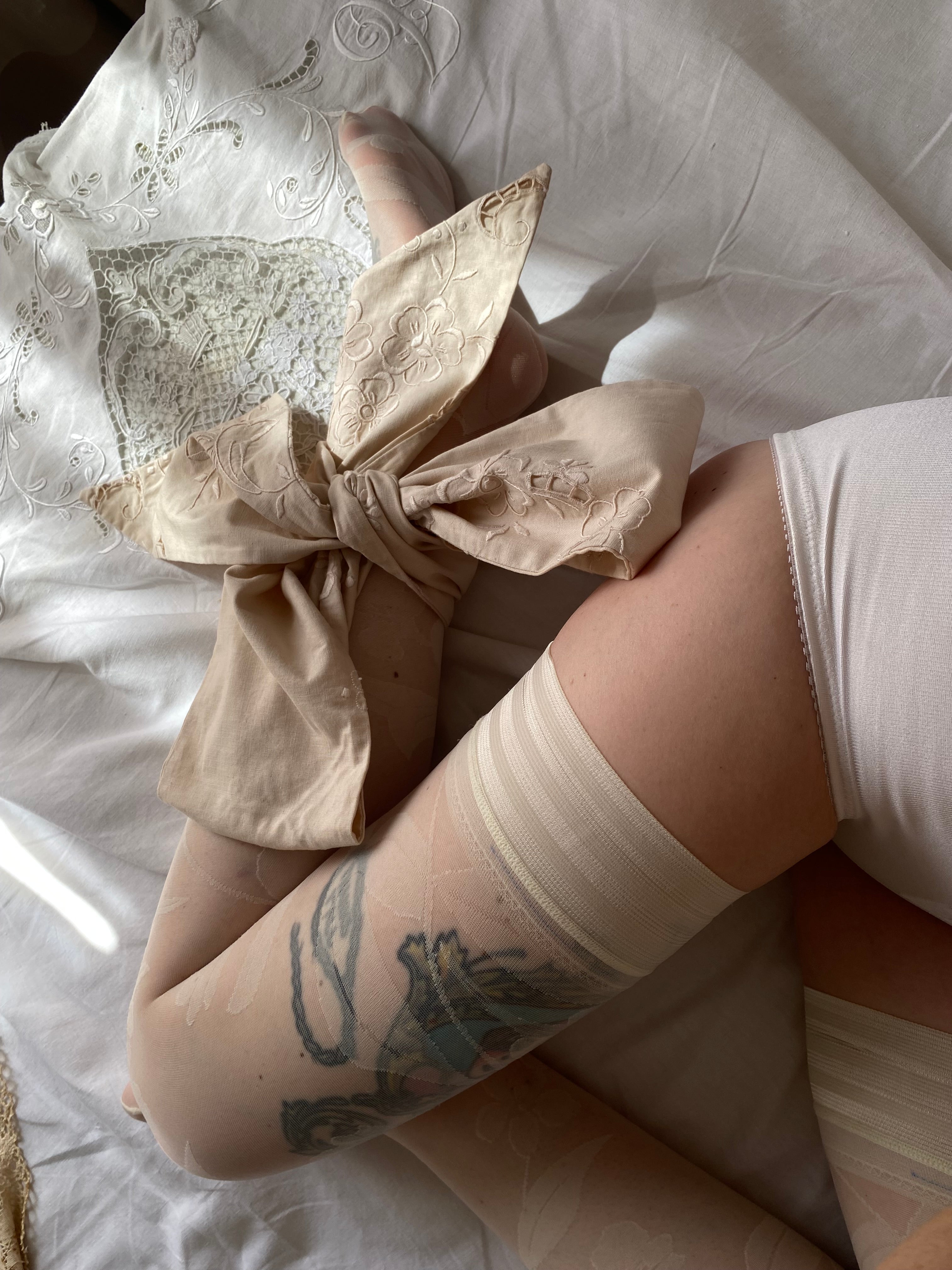 Tailored bow with antique embroidery