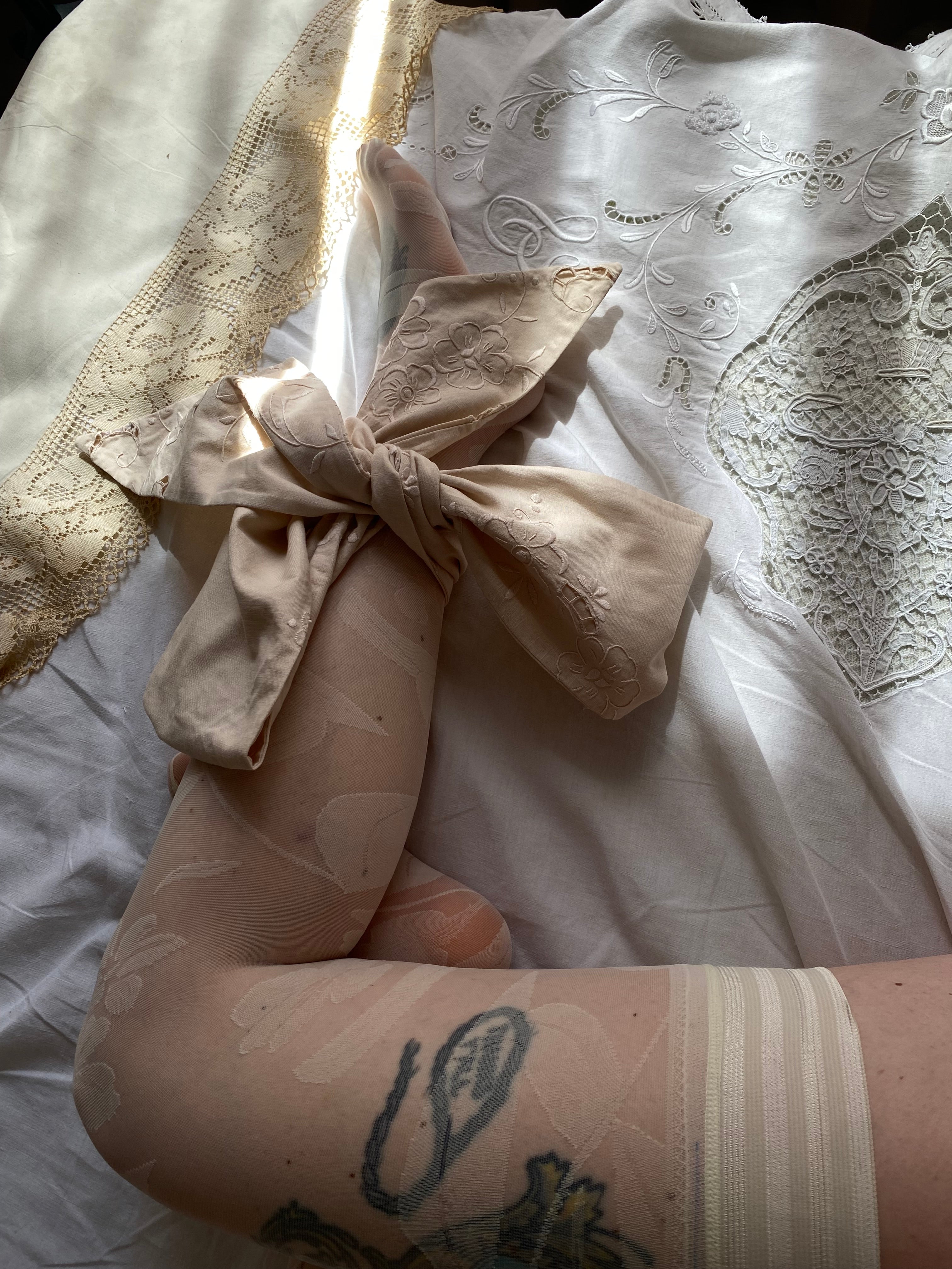 Tailored bow with antique embroidery