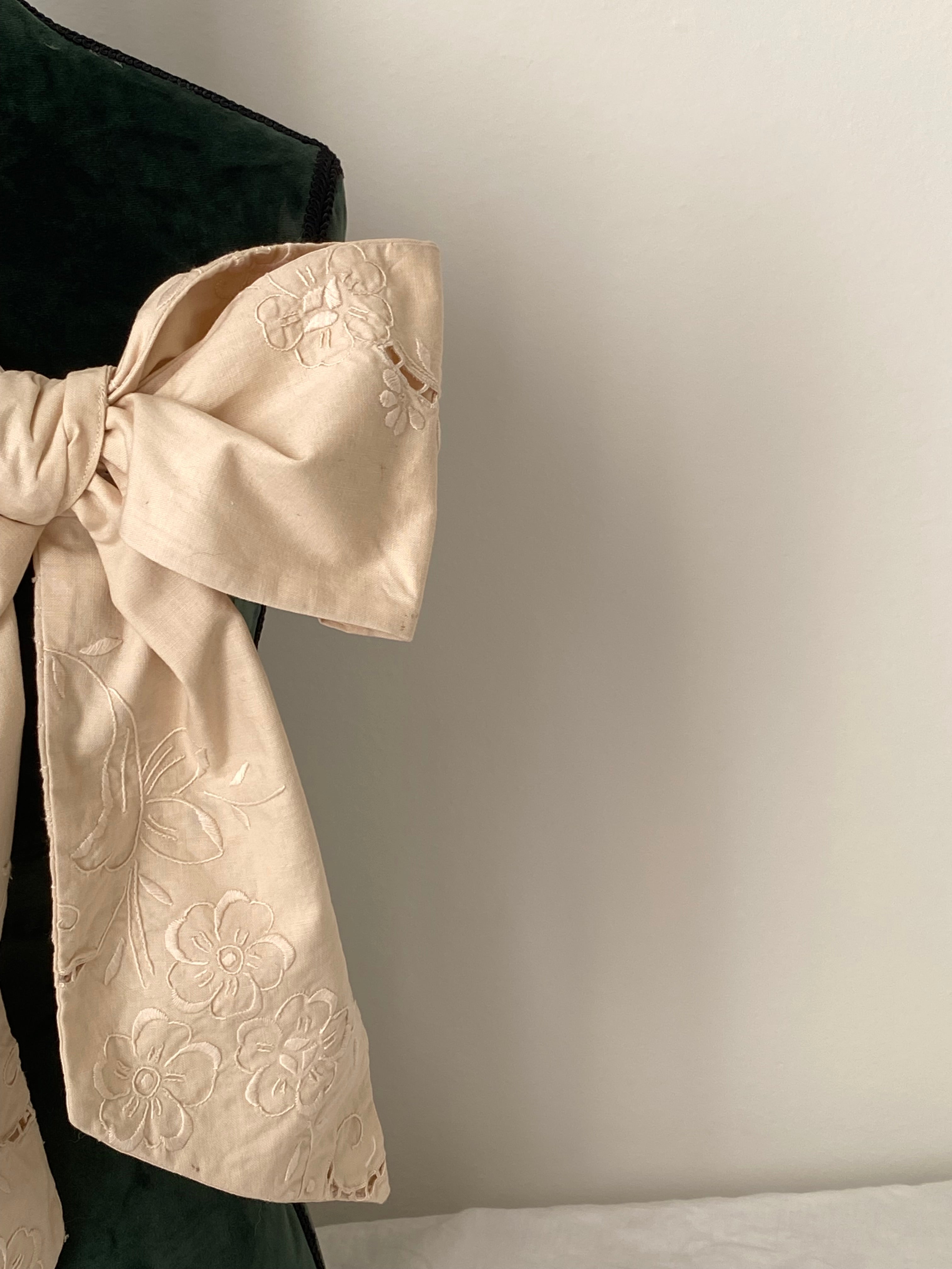 Tailored bow with antique embroidery