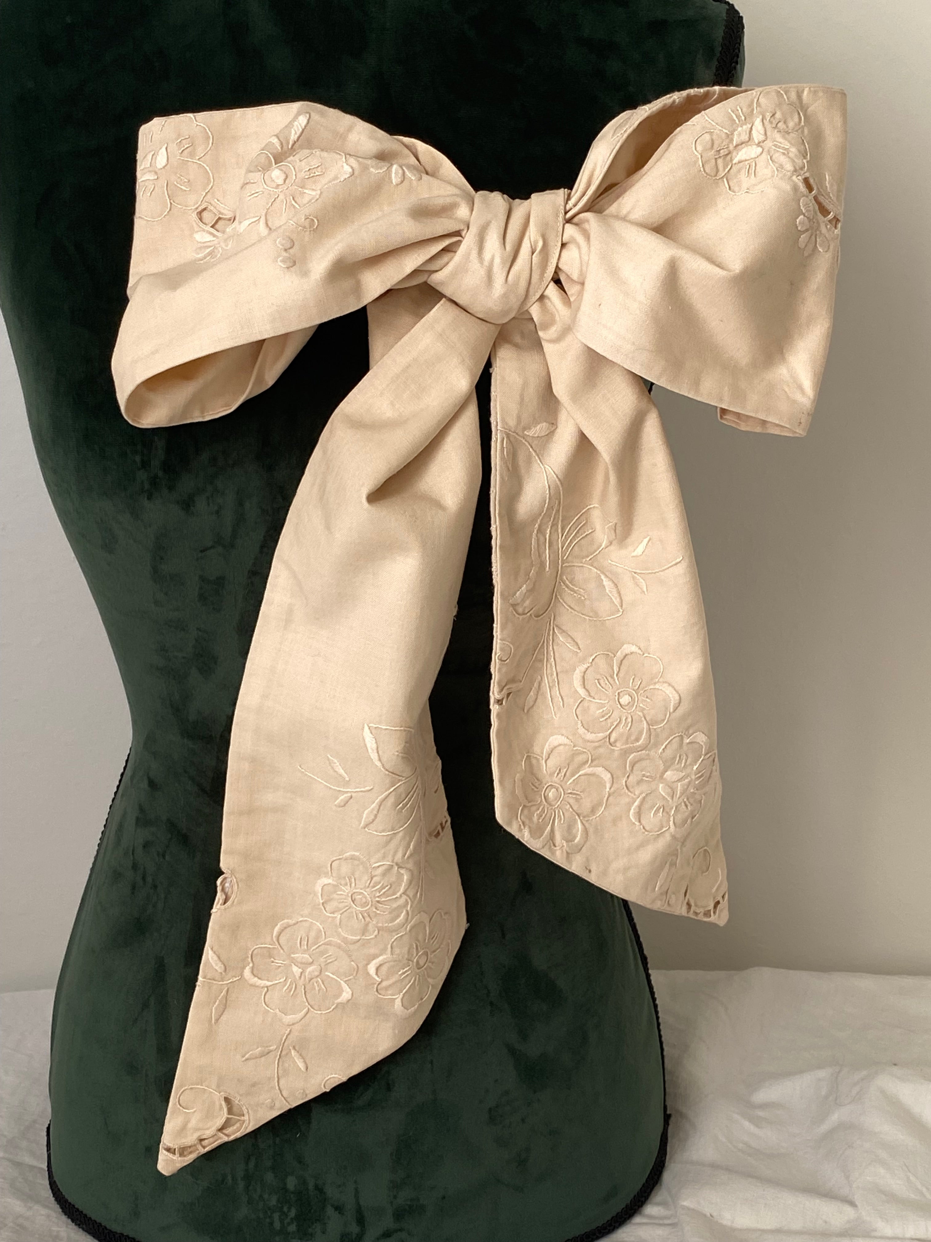 Tailored bow with antique embroidery